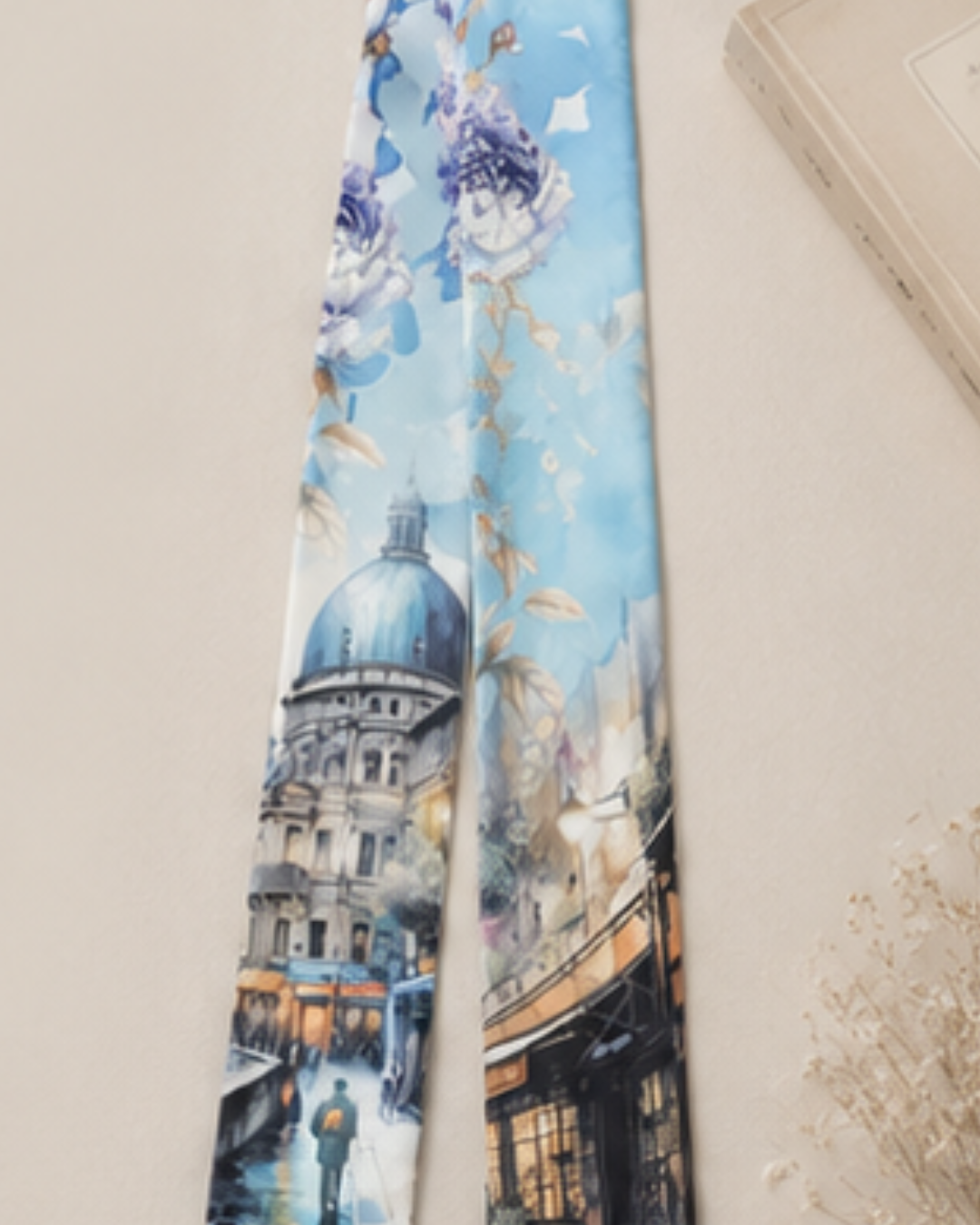 Tie with a scenic design of a building and people on a light blue background